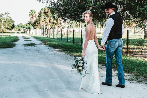 Bride and Groom walking down path at rustic old Florida estate