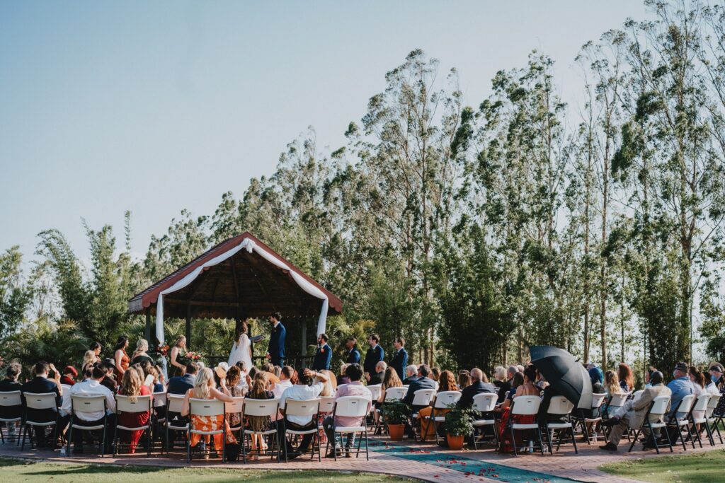 Photo Credit - Light Sky Photography - Kai-Kai Farm wedding showing guests in the audience as the bride and groom kiss