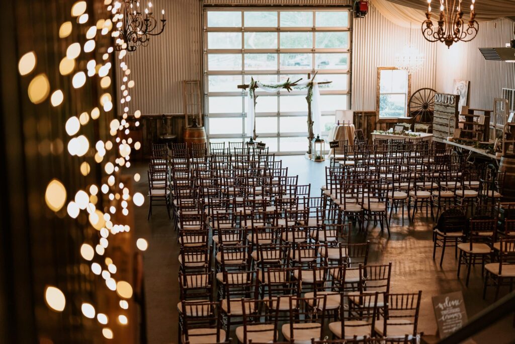 Interior shot of the Rockin H Ranch wedding venue showing rows of seating and fairy lights.