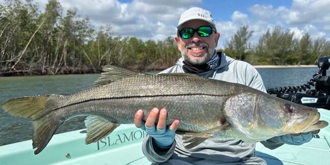 man holding snook