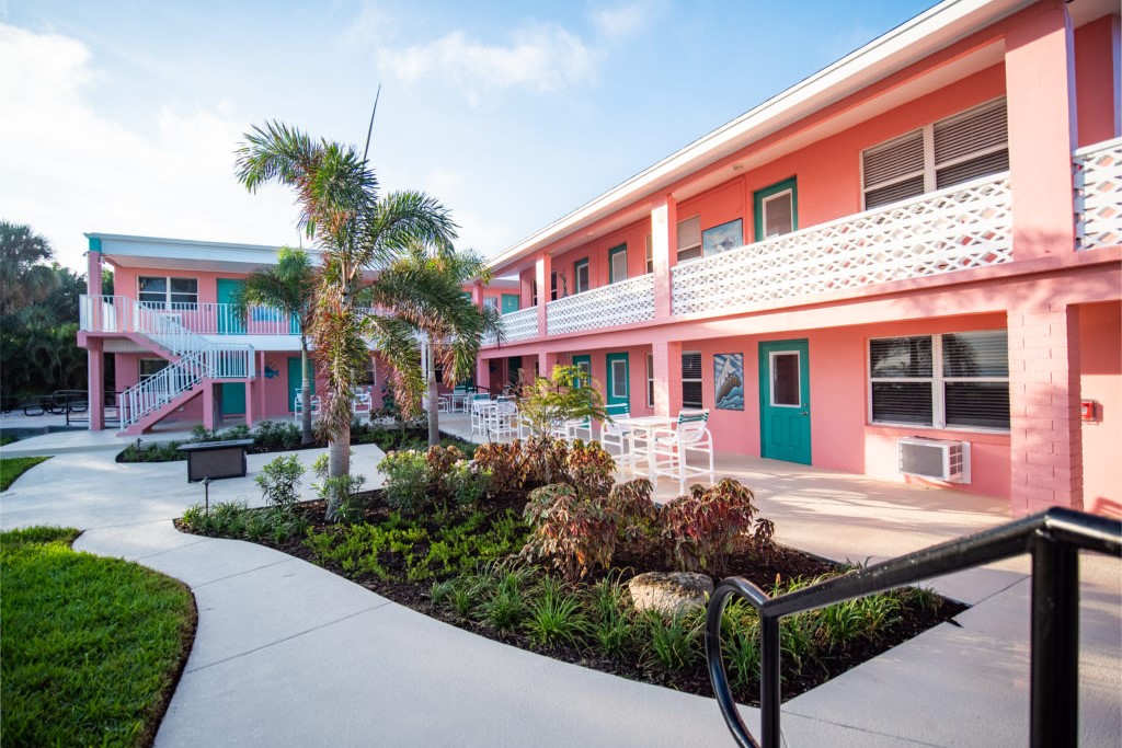 pink motel with palm tree