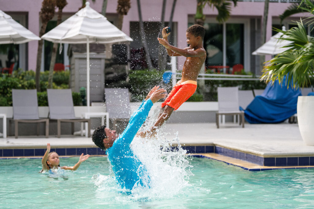 dad throwing son in hotel pool